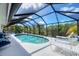 Enjoy the outdoors in this screened pool area with several lounge chairs and beautiful sunlight at 8320 Creekview Ln, Englewood, FL 34224