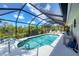 Bask in this screened pool, boasting a spacious deck for relaxing and fun in the Florida sun at 8320 Creekview Ln, Englewood, FL 34224