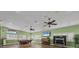 Spacious recreation room with hardwood floors, ceiling fans, and natural light for versatile use at 8320 Creekview Ln, Englewood, FL 34224