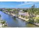 An aerial view of the waterfront featuring homes, palm trees, boat docks, and waterfront access to the canal at 8400 Antwerp Cir, Port Charlotte, FL 33981