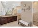 Bathroom with granite counters, dual sinks, large mirrors, and shower stall at 8400 Antwerp Cir, Port Charlotte, FL 33981