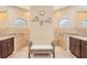 Bathroom with dual sinks, granite counters, and a bench between the two shower stalls at 8400 Antwerp Cir, Port Charlotte, FL 33981