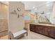 Bathroom with granite counters, lots of mirrors, shower, and decorative wall art at 8400 Antwerp Cir, Port Charlotte, FL 33981