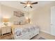 Bright bedroom features coastal decor, ceiling fan, and a comfortable bed with built-in storage drawers at 8400 Antwerp Cir, Port Charlotte, FL 33981