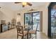 Bright breakfast nook with a glass table, seating for four, and views of the water at 8400 Antwerp Cir, Port Charlotte, FL 33981