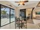 Bright breakfast nook with a glass table, modern chairs, and a view of the pool and outdoor area at 8400 Antwerp Cir, Port Charlotte, FL 33981