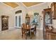 Dining room featuring a wood table set, decorative china cabinets, front door view, and elegant chandelier at 8400 Antwerp Cir, Port Charlotte, FL 33981