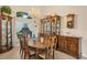 Formal dining area with traditional wood furniture, china cabinets, and a window with sheer curtains at 8400 Antwerp Cir, Port Charlotte, FL 33981