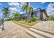 Beautiful home exterior with manicured landscaping leading to a canal waterfront at 8400 Antwerp Cir, Port Charlotte, FL 33981