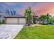 Beautiful home featuring a paver driveway leading to a spacious three-car garage at 8400 Antwerp Cir, Port Charlotte, FL 33981
