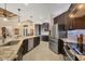 Gourmet kitchen with granite countertops, stainless appliances, dark wood cabinetry, and ample counter space at 8400 Antwerp Cir, Port Charlotte, FL 33981