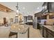 Bright kitchen showcasing a center island, dark wood cabinets, stainless appliances, and open living space at 8400 Antwerp Cir, Port Charlotte, FL 33981