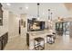 Open kitchen with dark cabinetry, granite countertops, island seating, and stainless steel appliances at 8400 Antwerp Cir, Port Charlotte, FL 33981