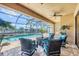 Covered lanai featuring comfortable seating with a beautiful view of the pool and waterfront at 8400 Antwerp Cir, Port Charlotte, FL 33981