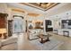 Spacious living room featuring modern furniture, tile flooring, high ceilings, and seamless kitchen integration at 8400 Antwerp Cir, Port Charlotte, FL 33981