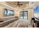 Living room with couch, ceiling fan, tray ceiling, and view of the pool at 8400 Antwerp Cir, Port Charlotte, FL 33981