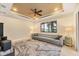 Spacious living room with a tray ceiling, ceiling fan, and large couch at 8400 Antwerp Cir, Port Charlotte, FL 33981