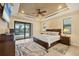 Main bedroom with tray ceiling, ceiling fan, and sliding glass doors leading to the pool at 8400 Antwerp Cir, Port Charlotte, FL 33981