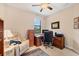 Well-lit home office has a comfortable recliner, ceiling fan, and functional workspace at 8400 Antwerp Cir, Port Charlotte, FL 33981