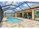 Inviting pool area with outdoor seating and stunning views of the home's exterior at 8400 Antwerp Cir, Port Charlotte, FL 33981