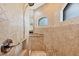Shower stall with granite bench, decorative tile, and view to bathroom vanity at 8400 Antwerp Cir, Port Charlotte, FL 33981