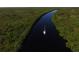 Aerial view of a waterway with a sailboat, showcasing the serene landscape and water access at 8400 Antwerp Cir, Port Charlotte, FL 33981