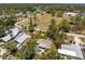 Aerial shot of a single-Gathering home with a screened-in pool and mature landscaping at 875 Morrison Ave, Englewood, FL 34223