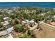 Breathtaking aerial view of a serene property showcasing a home and pool nestled within lush greenery near a stunning bay at 875 Morrison Ave, Englewood, FL 34223