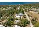 Breathtaking aerial view of a serene property showcasing a home and pool nestled within lush greenery near a stunning bay at 875 Morrison Ave, Englewood, FL 34223
