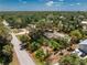 Aerial view shows a home in a mature tropical wooded community, circled in red for emphasis at 875 Morrison Ave, Englewood, FL 34223