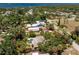 Aerial shot of a single-Gathering home with a screened-in pool and mature landscaping near the water at 875 Morrison Ave, Englewood, FL 34223