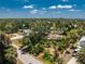 Birds-eye view of a home nestled in a tropical wooded community with mature trees at 875 Morrison Ave, Englewood, FL 34223