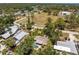 Beautiful aerial view showcasing the home's pool and lush surroundings in a desirable neighborhood at 875 Morrison Ave, Englewood, FL 34223