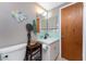 Cozy bathroom with unique decorative items, a toilet, and a single-sink vanity with storage at 875 Morrison Ave, Englewood, FL 34223