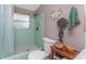 Bathroom with unique design elements: shower with window, artistic wall decor, and wooden accents at 875 Morrison Ave, Englewood, FL 34223