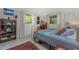 Bright bedroom features eclectic decor, natural light from multiple windows, and terrazzo flooring at 875 Morrison Ave, Englewood, FL 34223