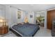 Bedroom with white walls and natural light, leading to an outdoor patio through sliding glass doors at 875 Morrison Ave, Englewood, FL 34223
