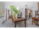 Open floor plan featuring a rustic dining table and access to the kitchen and living areas at 875 Morrison Ave, Englewood, FL 34223
