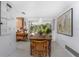 Dining room with access to kitchen and outside area, featuring a vintage-style wooden table at 875 Morrison Ave, Englewood, FL 34223