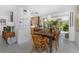 Dining area features a wood table, wicker chairs, and a view of the outdoor patio at 875 Morrison Ave, Englewood, FL 34223