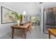 Open dining area with vintage table, stainless steel fridge, and views of the living room at 875 Morrison Ave, Englewood, FL 34223