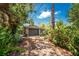 Charming home with a garage and driveway, surrounded by lush greenery and mature trees, offering a secluded and private setting at 875 Morrison Ave, Englewood, FL 34223