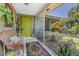 Welcoming front porch with a vibrant green door, offering a charming entrance and curb appeal at 875 Morrison Ave, Englewood, FL 34223