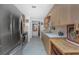 Functional kitchen with stainless steel appliances, plenty of cabinet space, and a view of the hallway at 875 Morrison Ave, Englewood, FL 34223