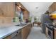 The kitchen features classic wood cabinets and is open to the dining space at 875 Morrison Ave, Englewood, FL 34223