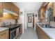 Kitchen with wood cabinets, stainless steel appliances, and a view into the dining area at 875 Morrison Ave, Englewood, FL 34223