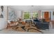Bright living room with large windows, a modern rug, stylish seating, and unique decor at 875 Morrison Ave, Englewood, FL 34223