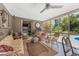 Relaxing screened patio with comfortable seating, perfect for enjoying the lush backyard views at 875 Morrison Ave, Englewood, FL 34223