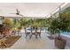 Inviting screened porch with seating area overlooking the pool and lush backyard at 875 Morrison Ave, Englewood, FL 34223