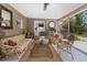 Cozy screened porch with a view to the bedroom offering a comfortable space to unwind at 875 Morrison Ave, Englewood, FL 34223
